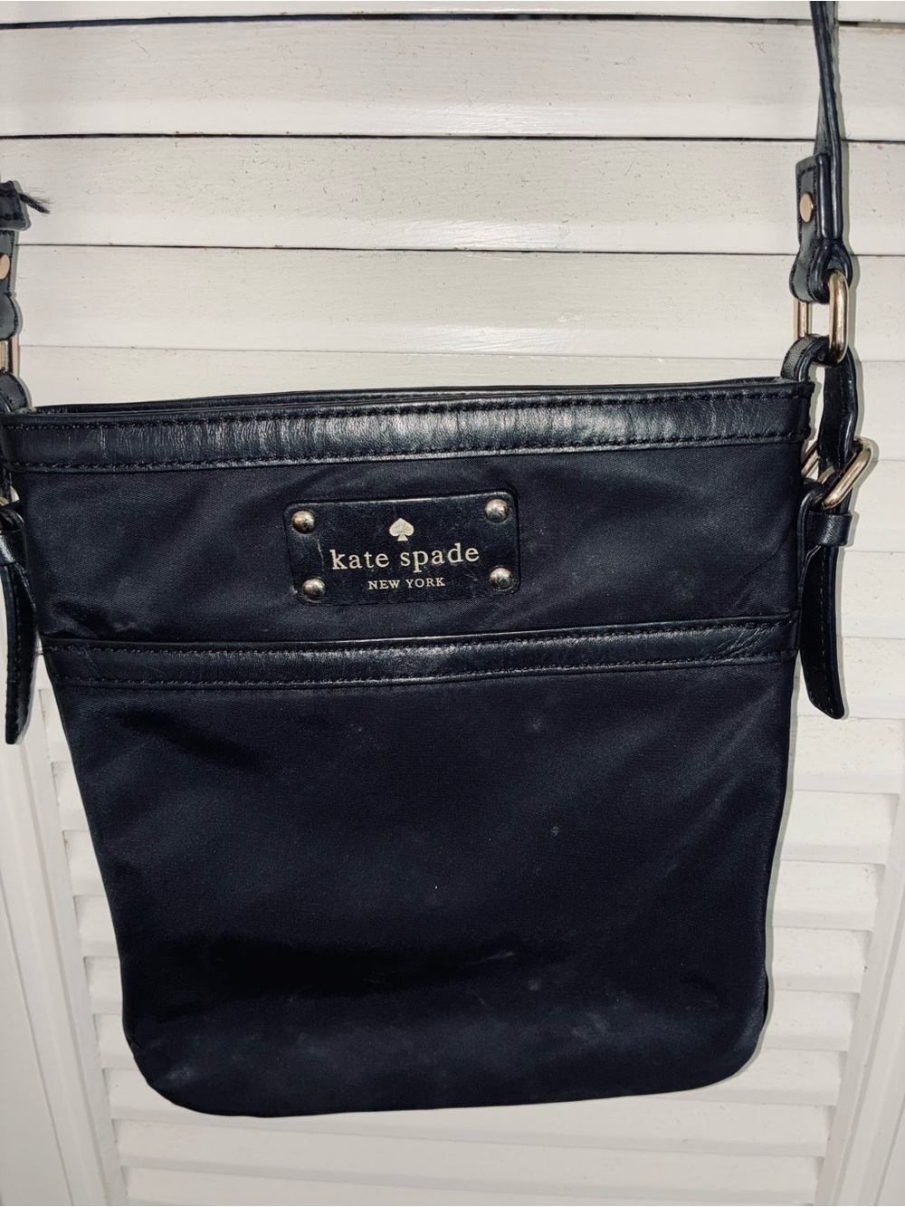 kate spade black crossbody bag with gold-tone plaque